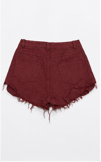 Short de mezclilla desgastado con botones al frente